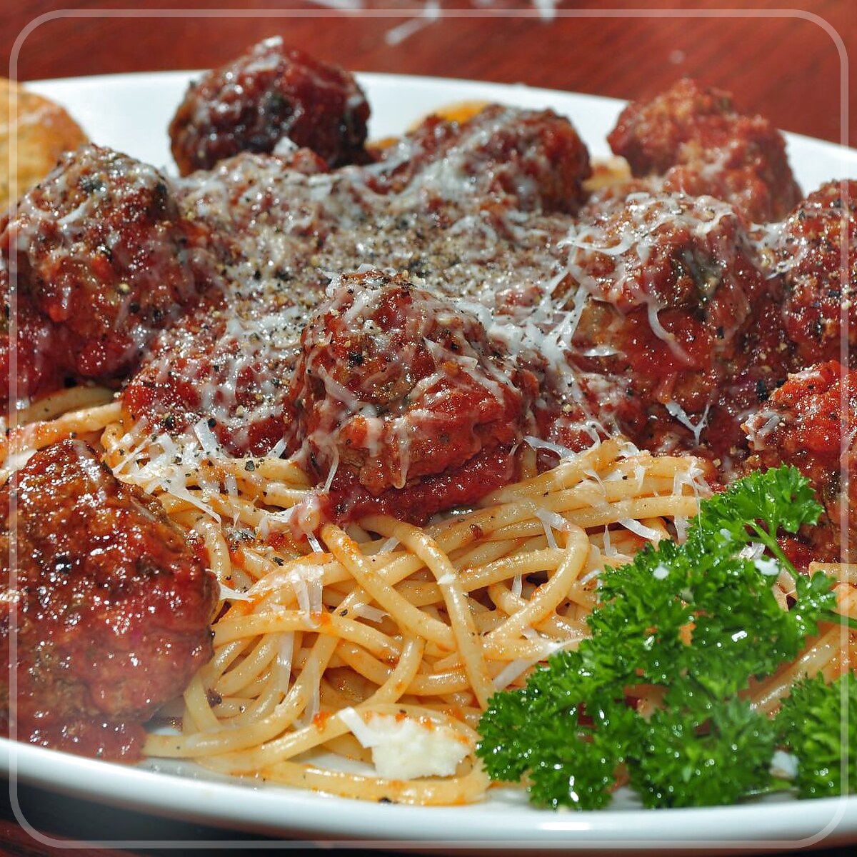 A plated serving of Meatballs And Tomato Sauce - Served Over Pasta
